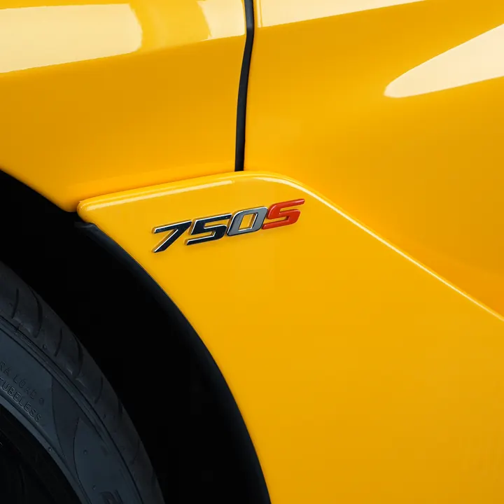 McLaren 750S badge on a yellow front fender